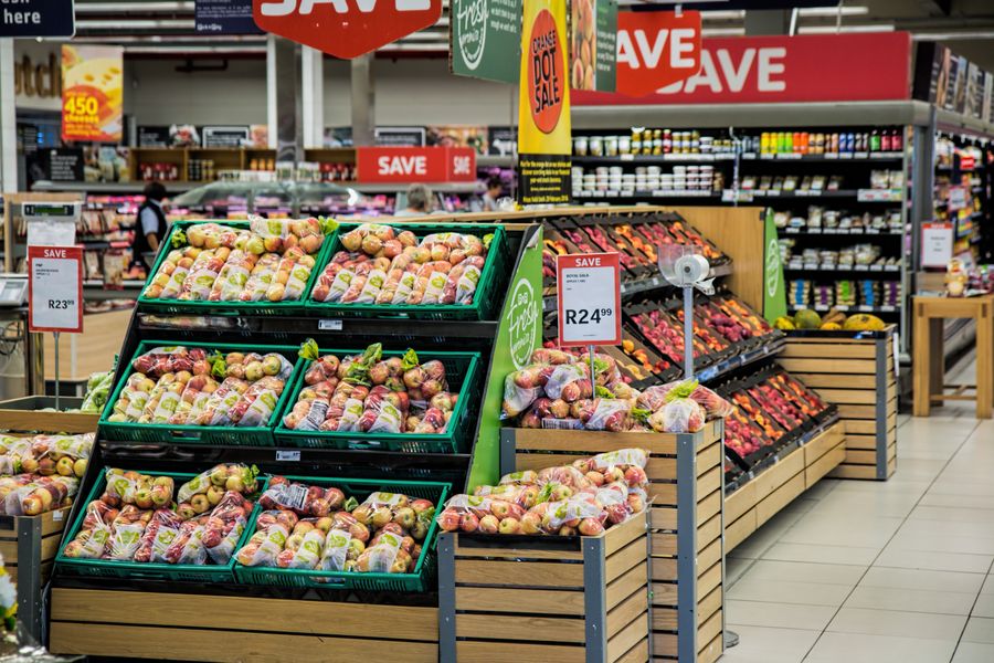 Retail supermarket shelves stocked with consumer goods